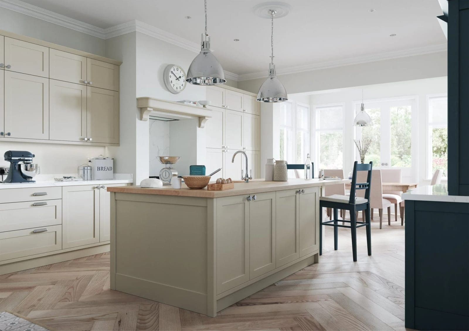 Sage green island with cream upper cabinets, brass hardware, zellige tile splashback